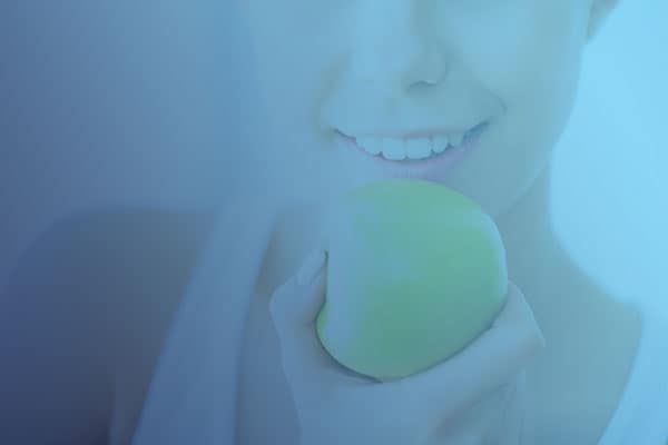 Smiling Lady with a green apple